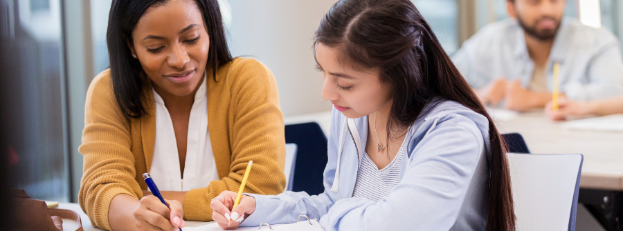 3 of 3, Teacher helping a student.